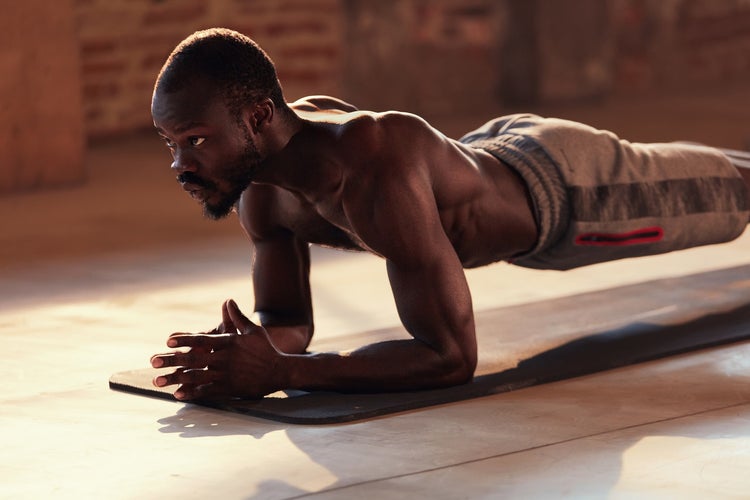 Man doing plank exercise on fitness workout at gym